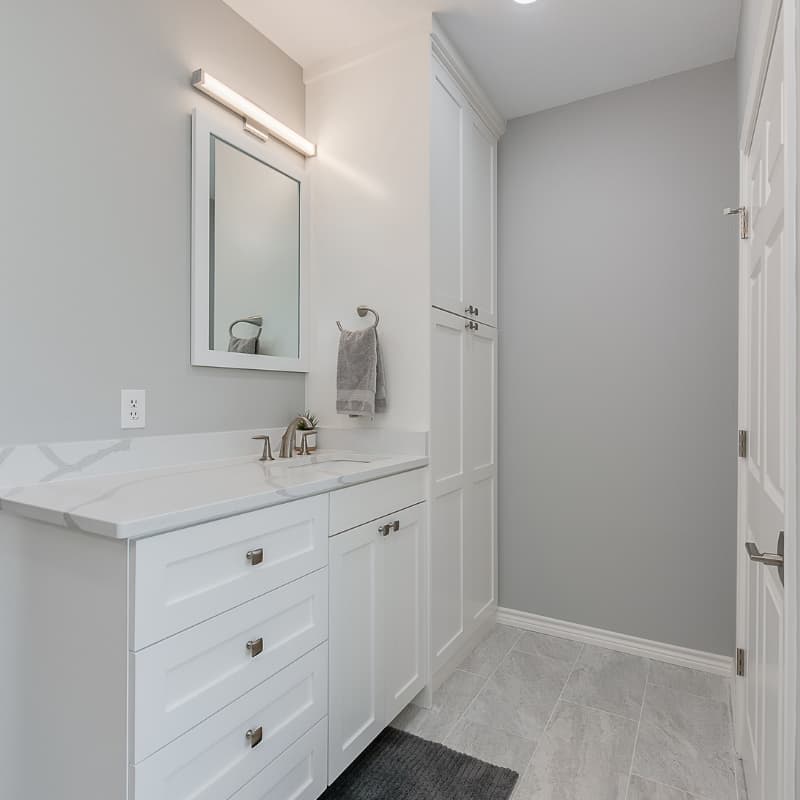 Shower with frameless glass and marble tile
