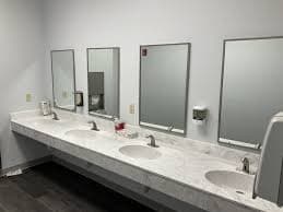 Modern commercial restroom with multiple stalls